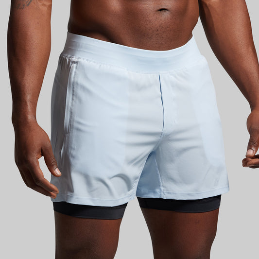 Light blue athletic shorts worn by a person on a plain background