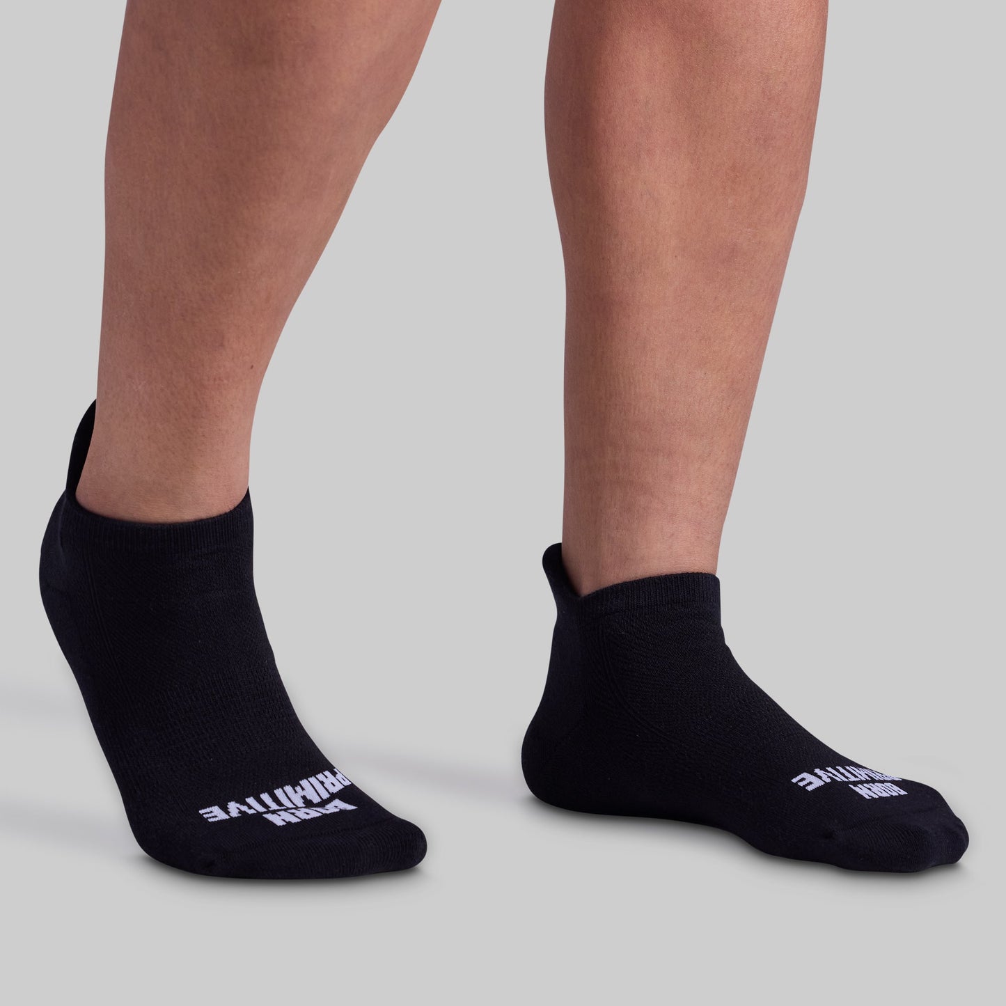 Black ankle socks with visible branding on a neutral background
