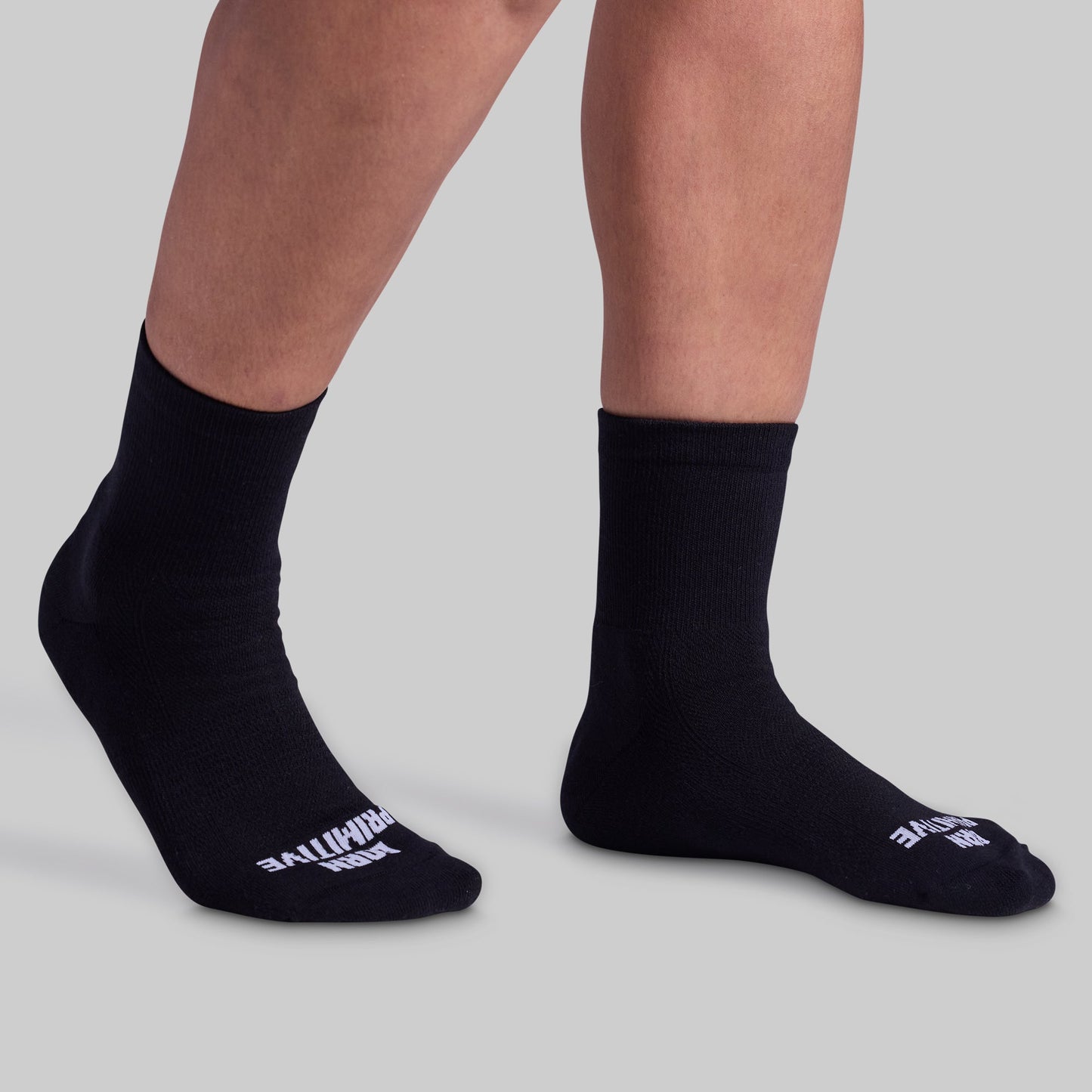 Black socks with visible branding on a light gray background