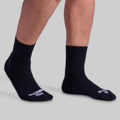 Black socks with visible branding on a light gray background