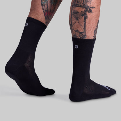 Performance Crew Sock (Black): side view with one heel lifted.