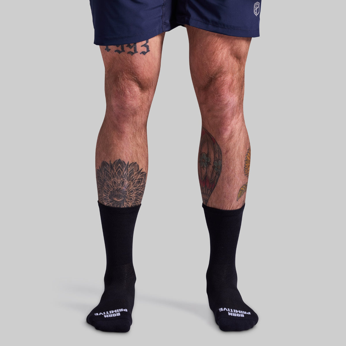 Performance Crew Sock (Black): worn with shorts in a front view.