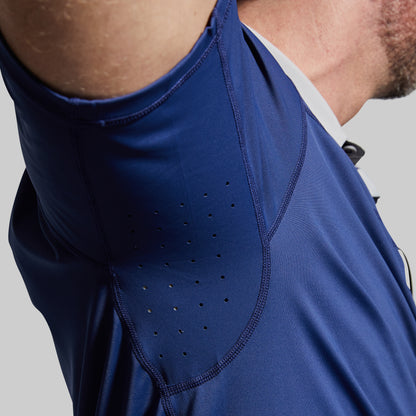 Close-up of a blue athletic shirt with perforated design on a gray background