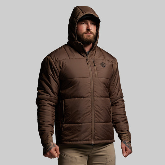 Man wearing a brown hooded jacket on a gray background
