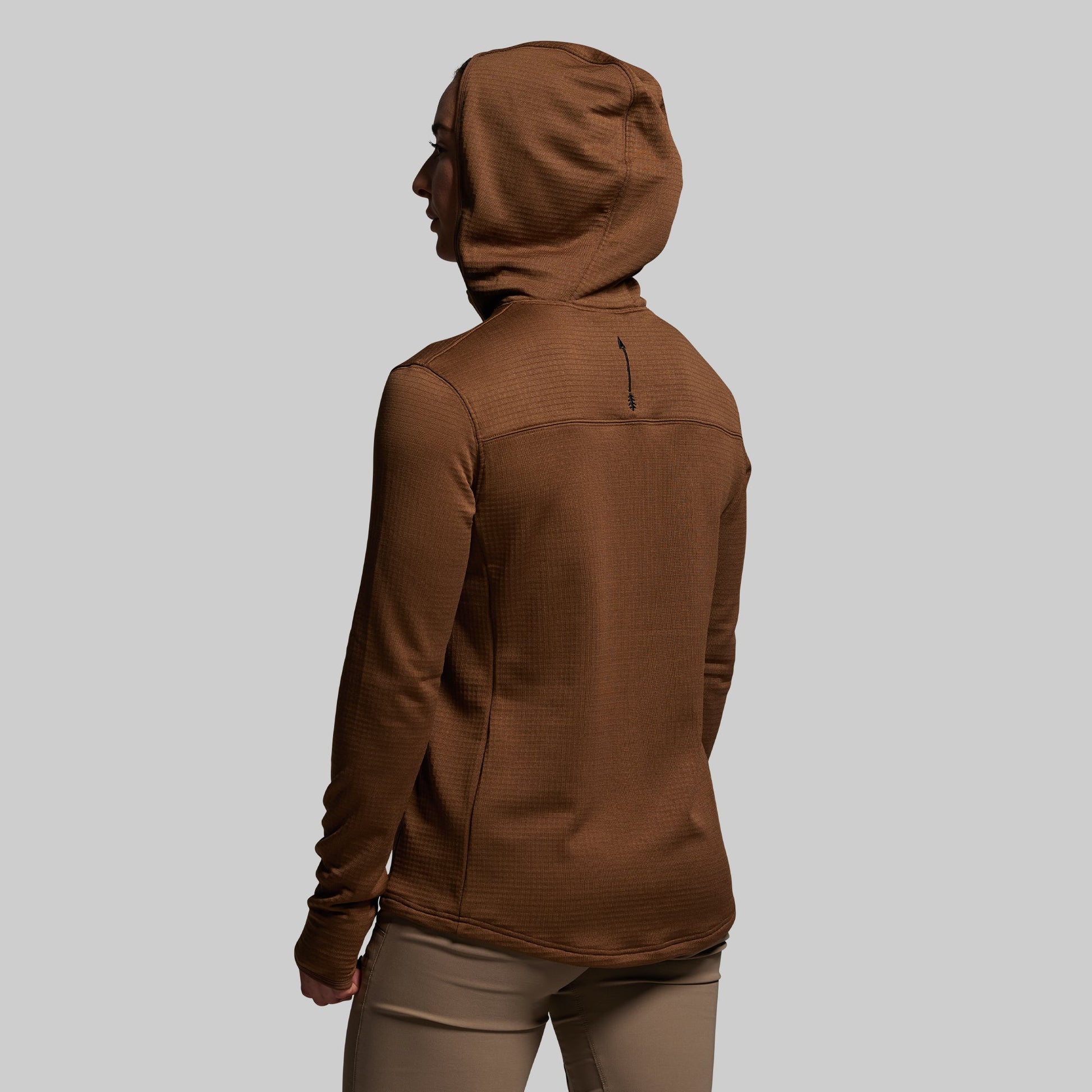 Brown hoodie worn by a person on a light gray background