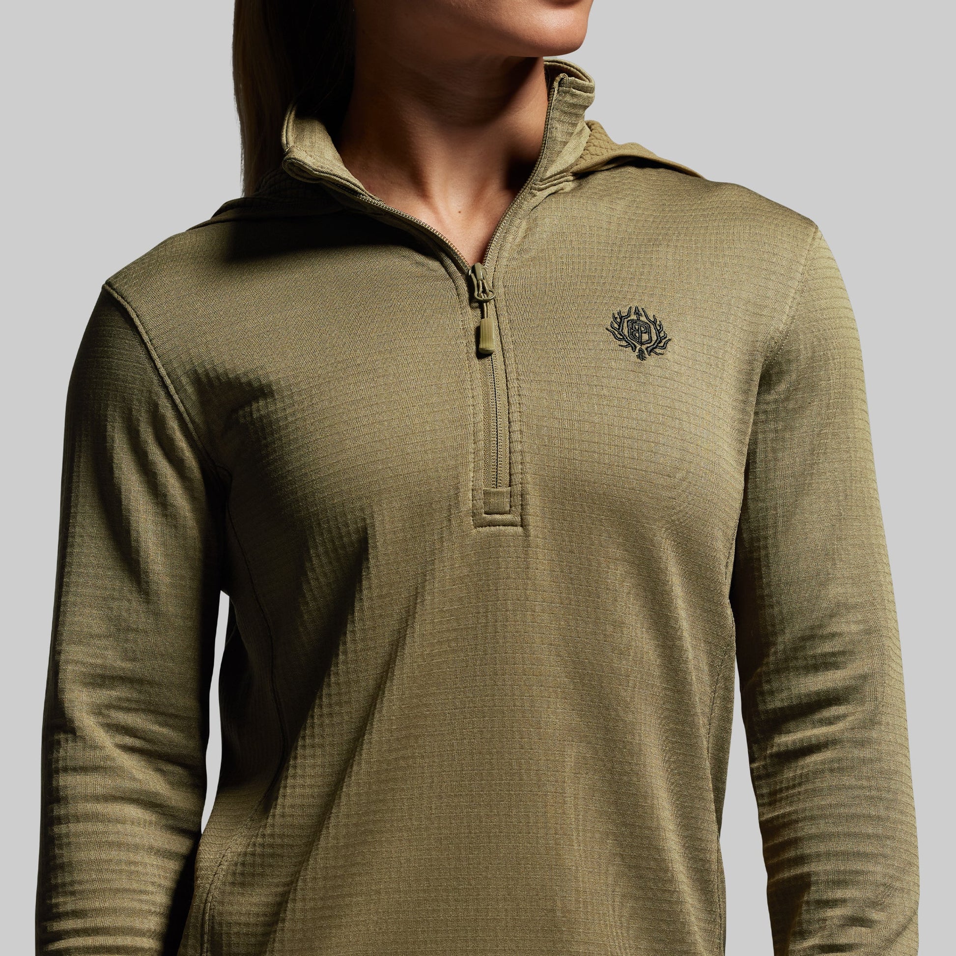 Green pullover with a logo on a gray background