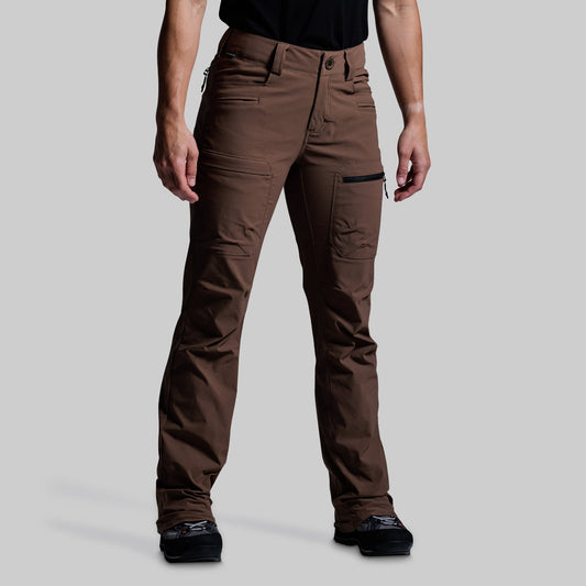 Brown outdoor pants worn by a person on a gray background
