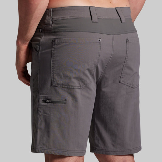 Gray shorts with multiple pockets and zippers on a gray background