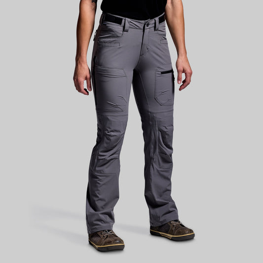 Person wearing gray outdoor pants on a light gray background