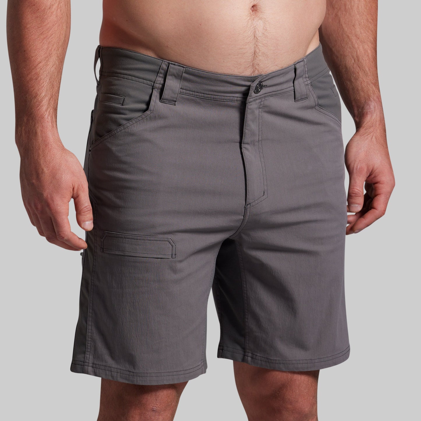 Gray shorts worn by a person on a plain background