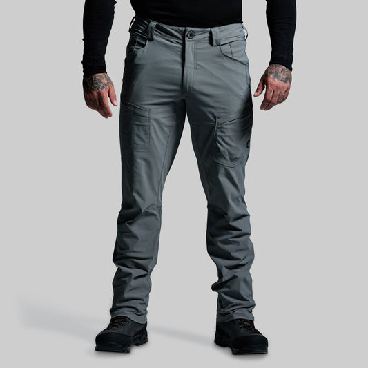 Person wearing gray outdoor pants on a light gray background