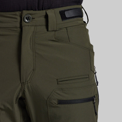 Close-up of olive green outdoor pants showing the waistband with a button closure, belt loop, and side cargo pocket with a zippered pocket on a light gray background.