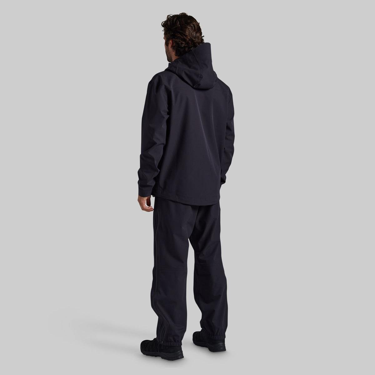 Back view of black Mission FLEX Rain Pant 2.0 with matching rain jacket