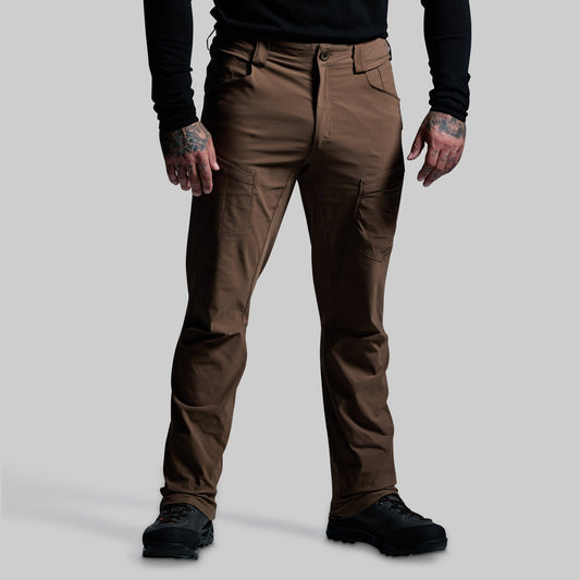 Brown pants worn by a person on a gray background