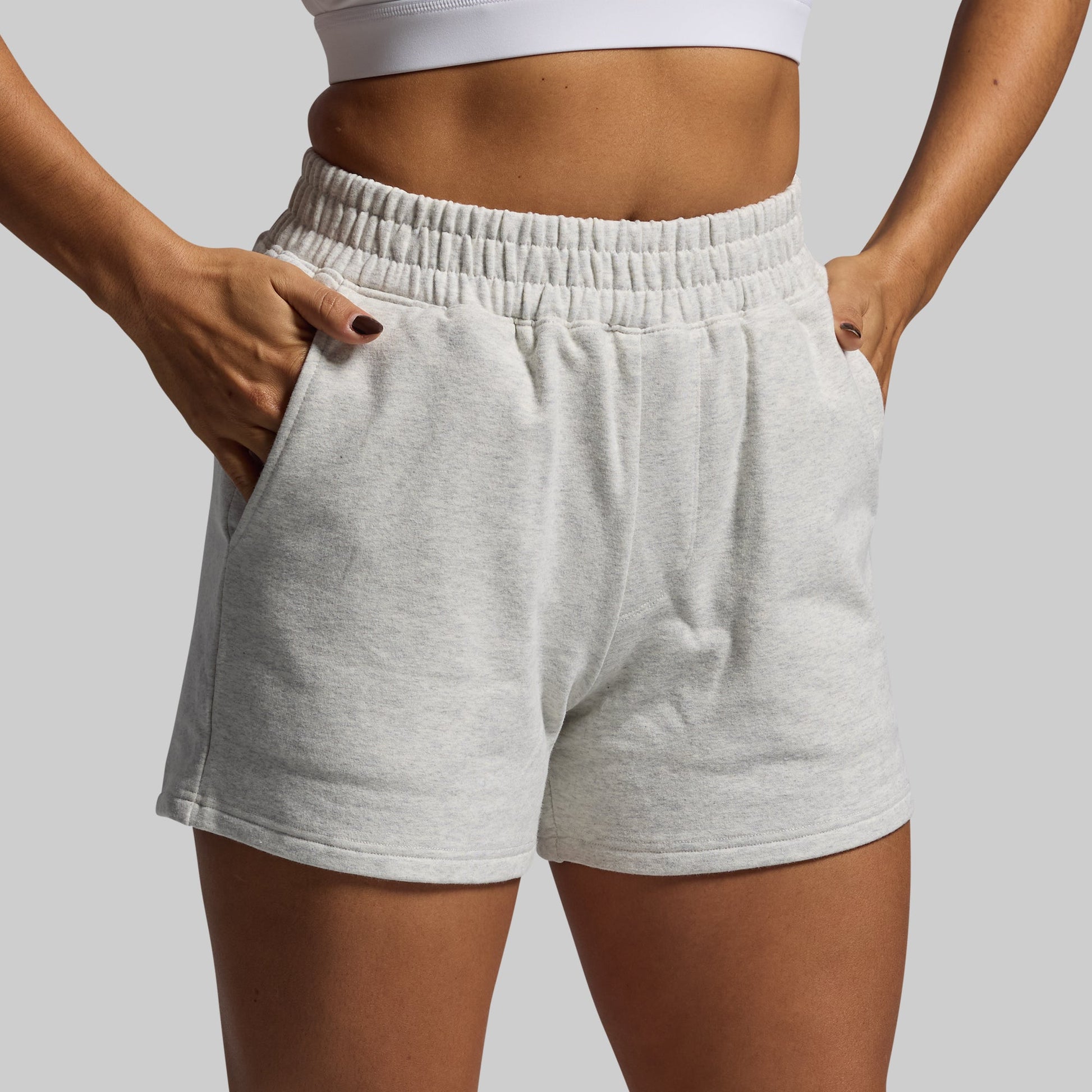 Gray shorts worn by a person on a plain background