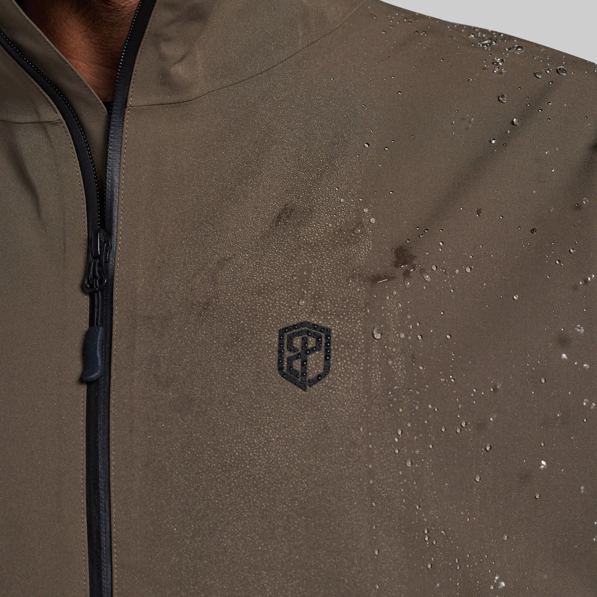 Water beading on the chest of the Ranger Green Mission FLEX Rain Jacket 2.0