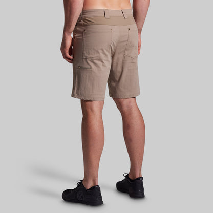 Beige shorts worn by a person on a gray background