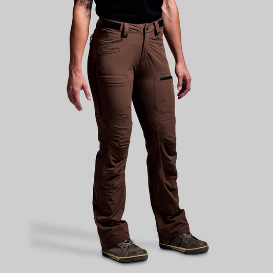 Person wearing brown pants on a gray background