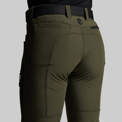 Close-up rear view of a person wearing olive green outdoor pants with a black belt, shown against a light gray studio background.
