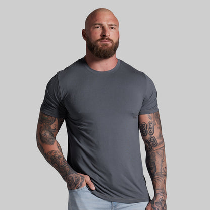 Man wearing a gray t-shirt against a plain background