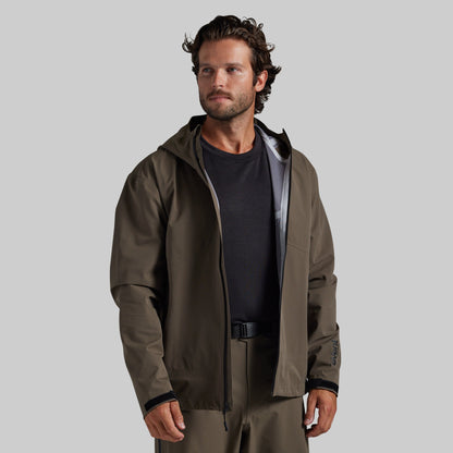 Man wearing the Ranger Green Mission FLEX Rain Jacket 2.0 open over a base layer