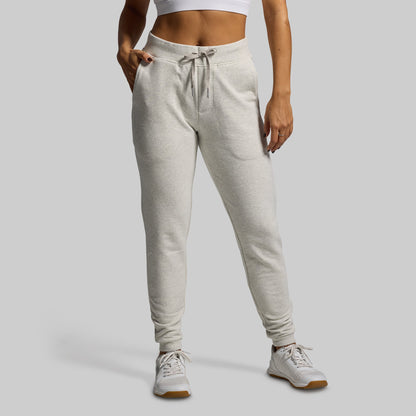 Person wearing light gray sweatpants on a plain background