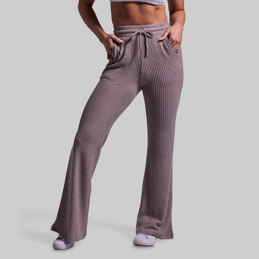 Person wearing ribbed lounge pants on a plain background