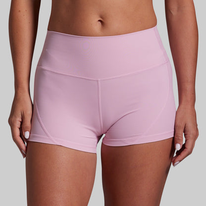 Pink athletic shorts worn by a person on a gray background