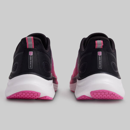 Black and pink athletic shoes on a gray background