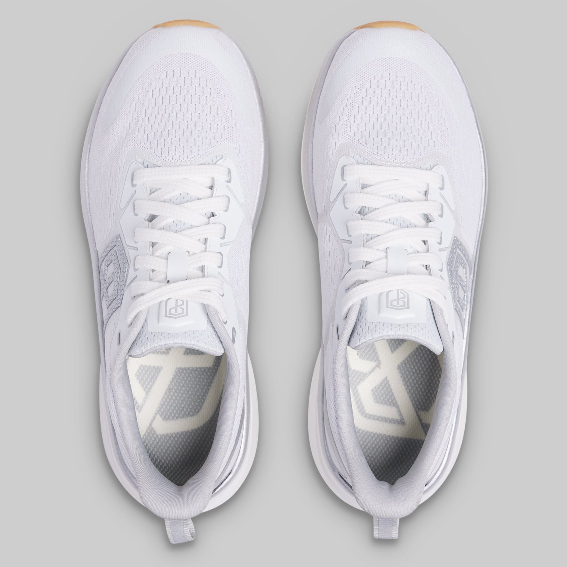 White athletic shoes on a gray background