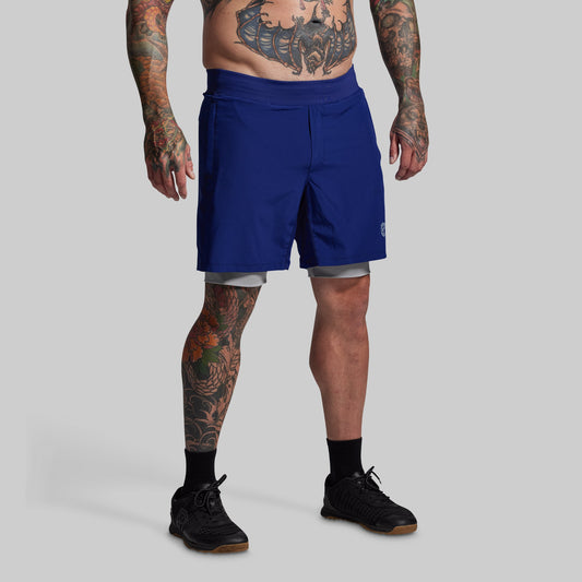 Person wearing blue shorts on a gray background