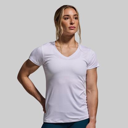 Woman wearing a white t-shirt against a gray background