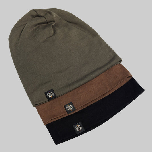 Three beanie hats in green, brown, and black with brand logos on a gray background