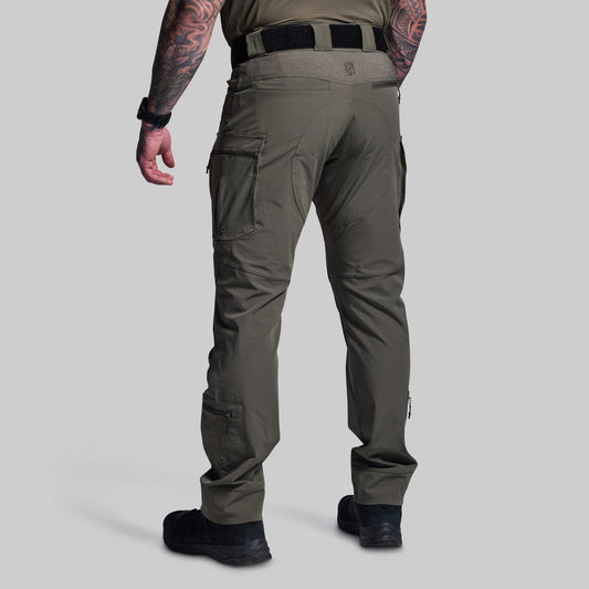 Person wearing green tactical pants on a light gray background
