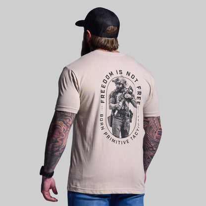 Man wearing a beige t-shirt with a graphic design and text on the back, standing against a plain background.