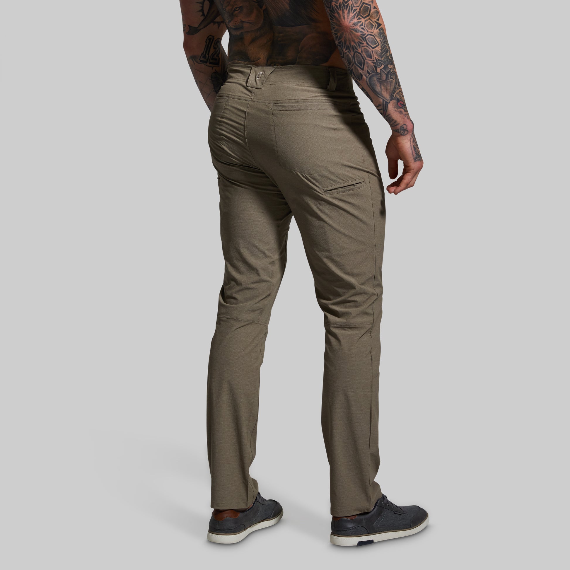 Person wearing beige pants on a gray background