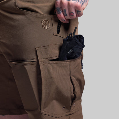 Brown shorts with a pocket containing a black item on a gray background