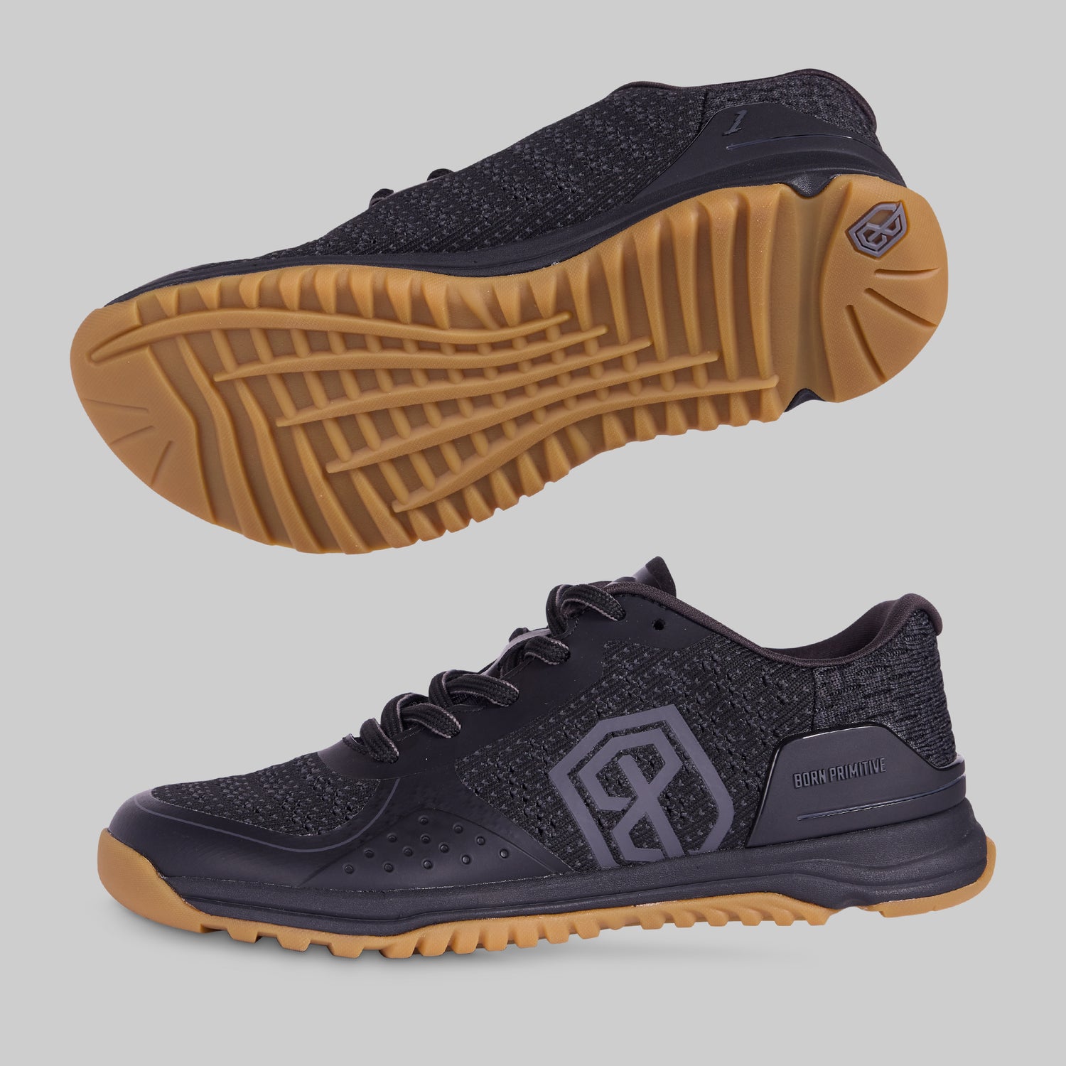 A pair of men's training shoes with black upper mesh material and a gum-colored outsole.
