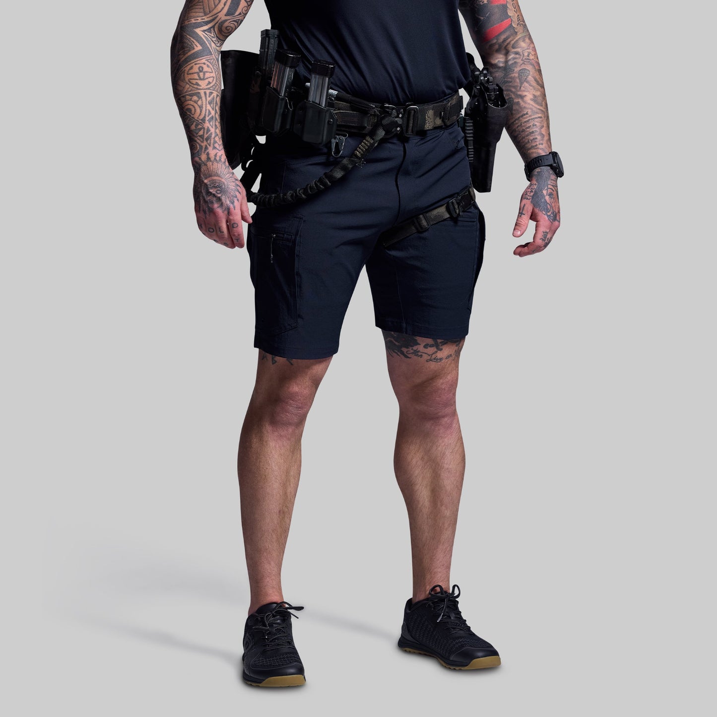 Person wearing tactical gear on a plain background
