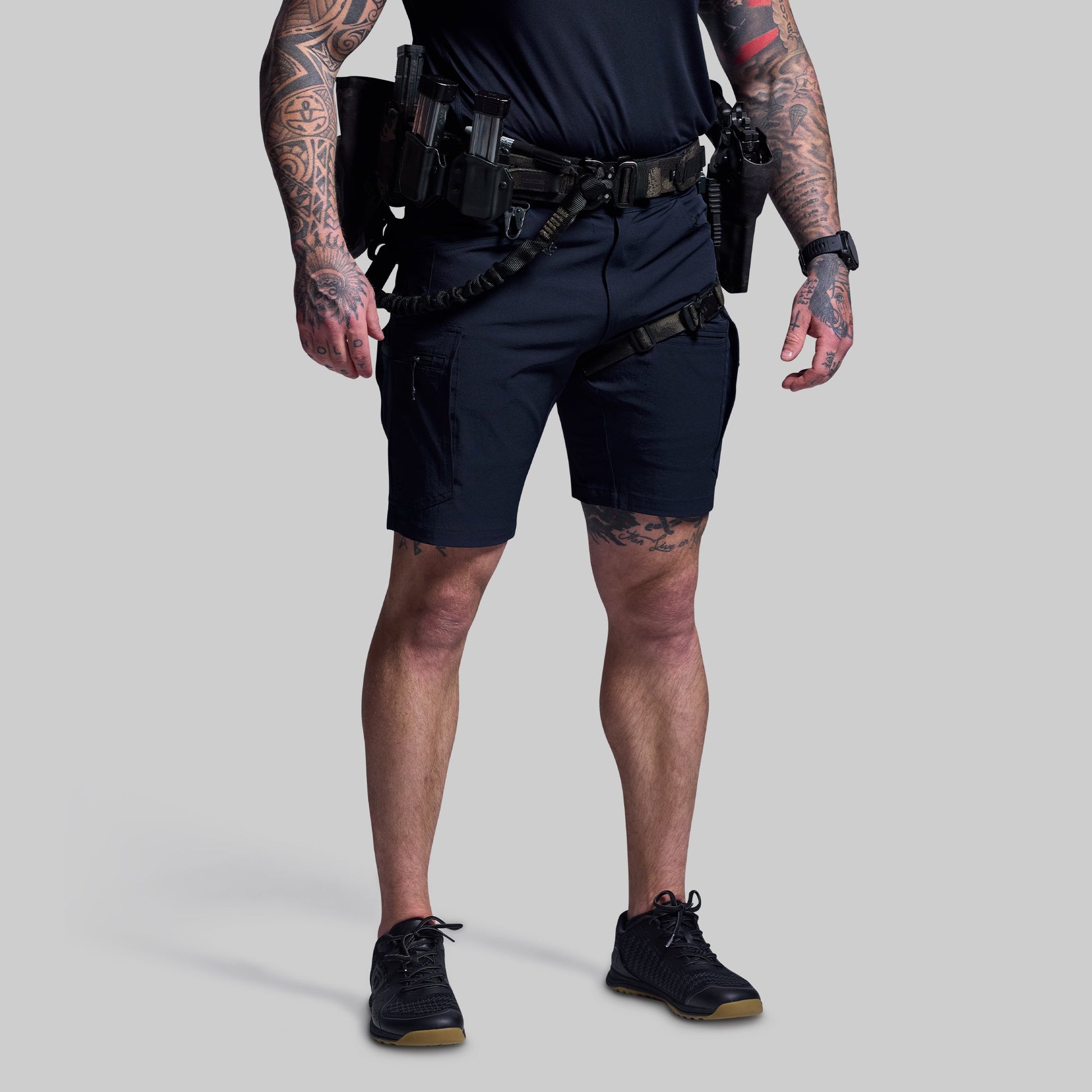 Person wearing tactical gear on a plain background