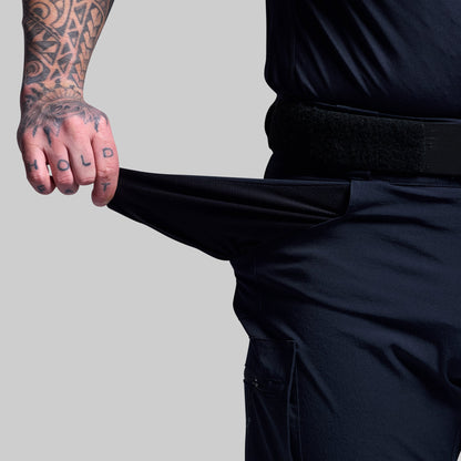 Person wearing dark blue shorts showing the pocket fabric.