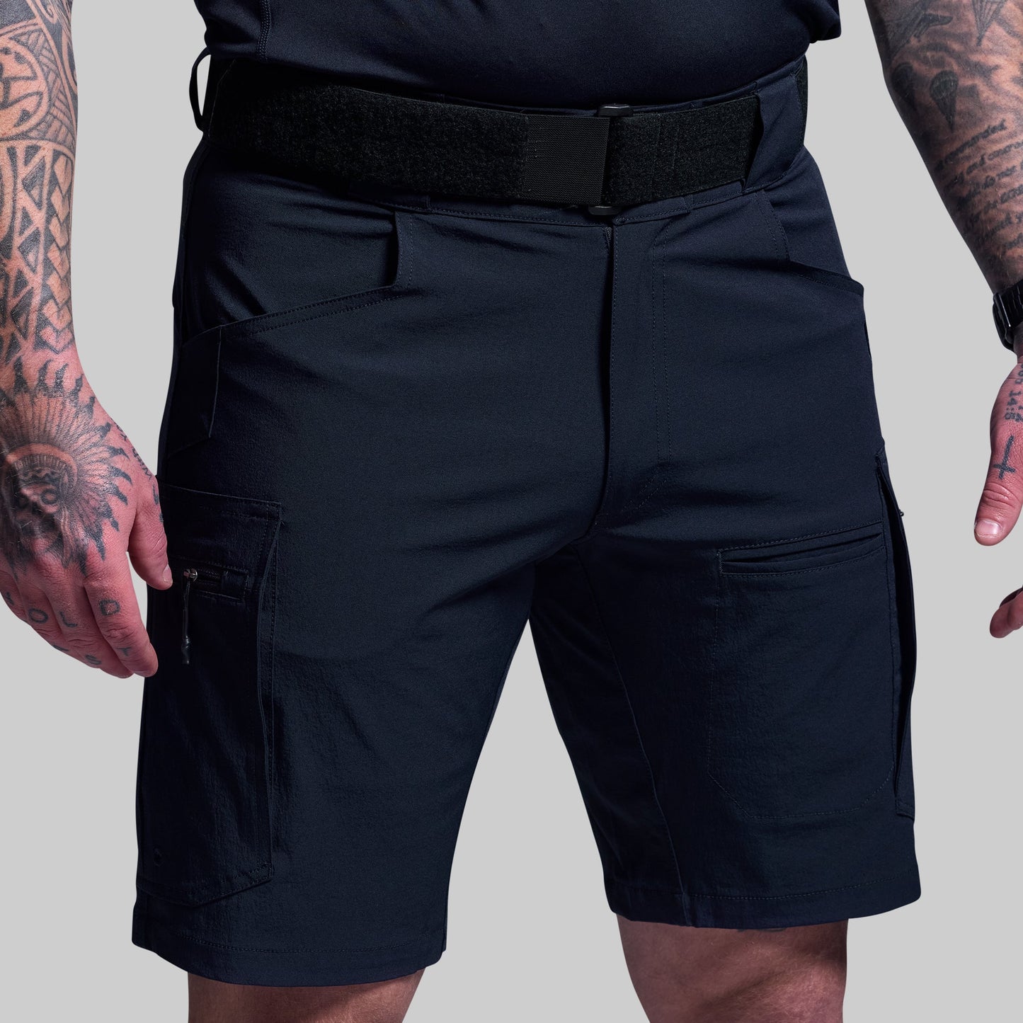 Blue tactical shorts worn by a person on a plain background