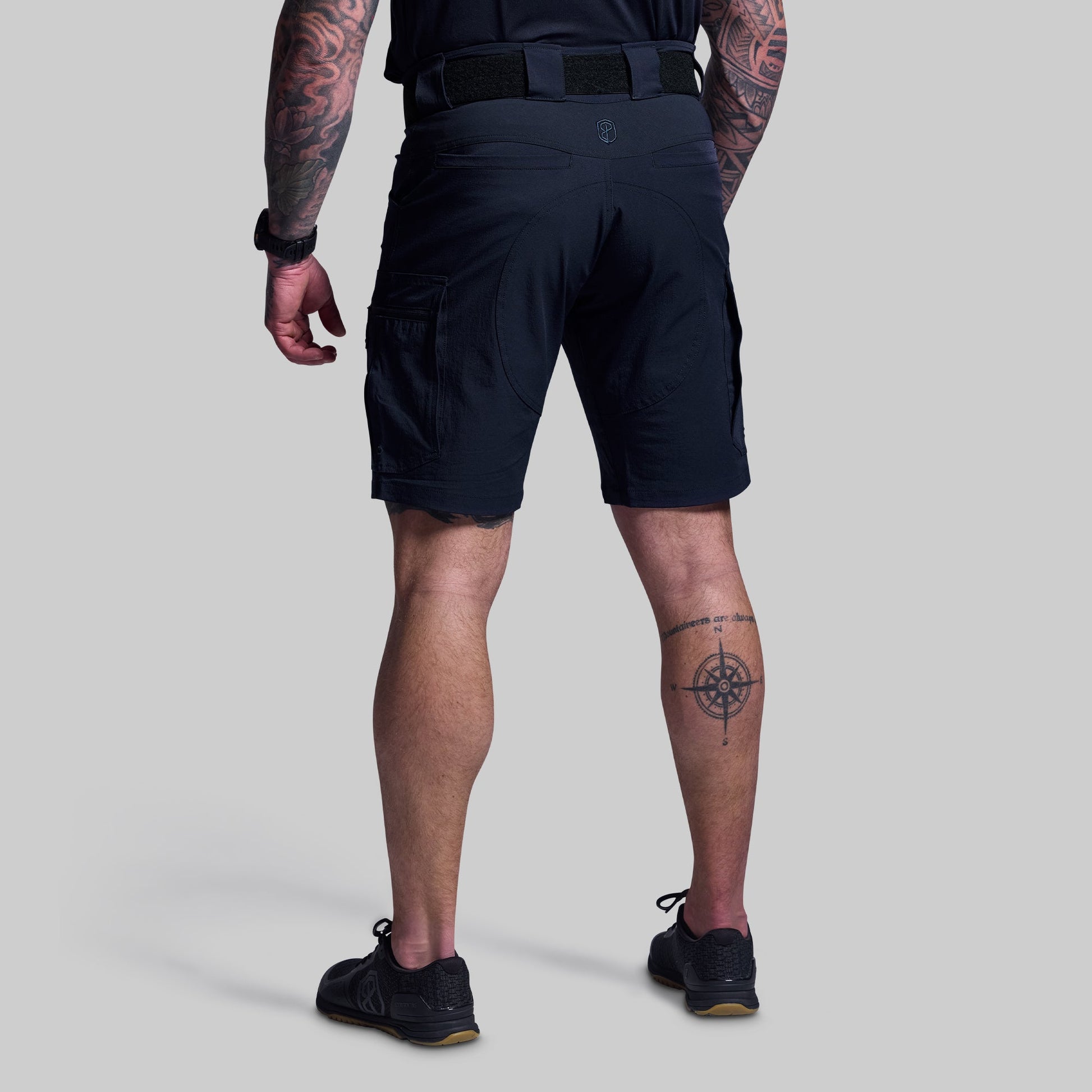Person wearing blue shorts on a light gray background