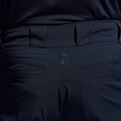 Close-up of dark blue tactical shorts with a visible brand logo on the waistband.