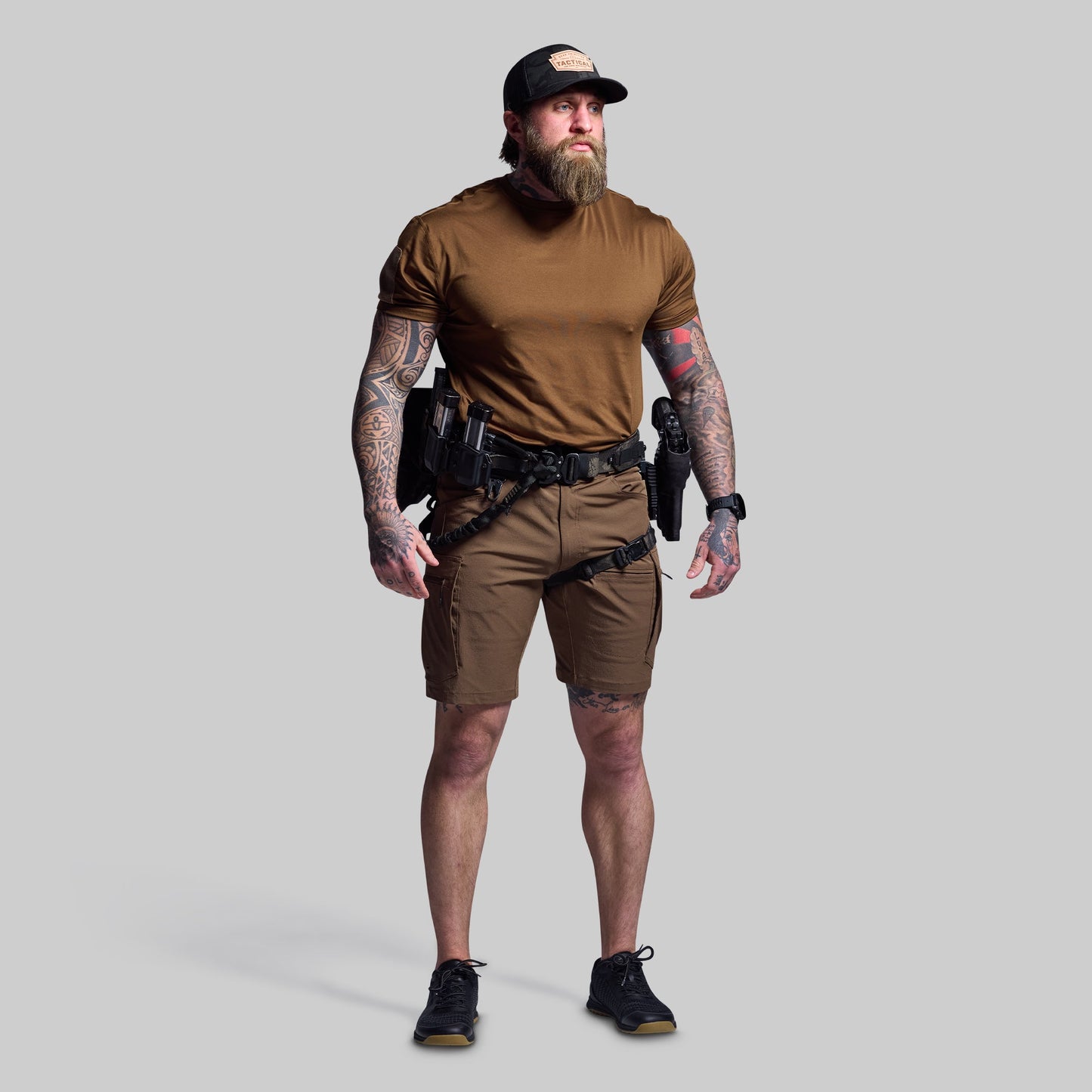 Man wearing tactical gear on a gray background