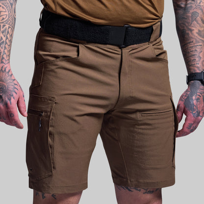 Brown tactical shorts worn by a person with tattoos on a plain background