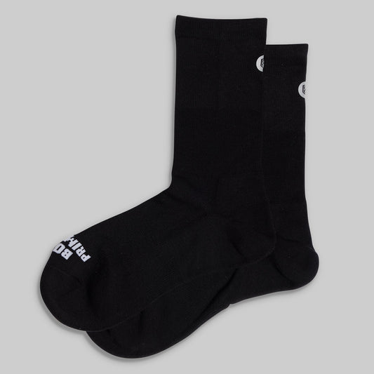 Performance Crew Sock (Black): pair laid flat showing white branding.