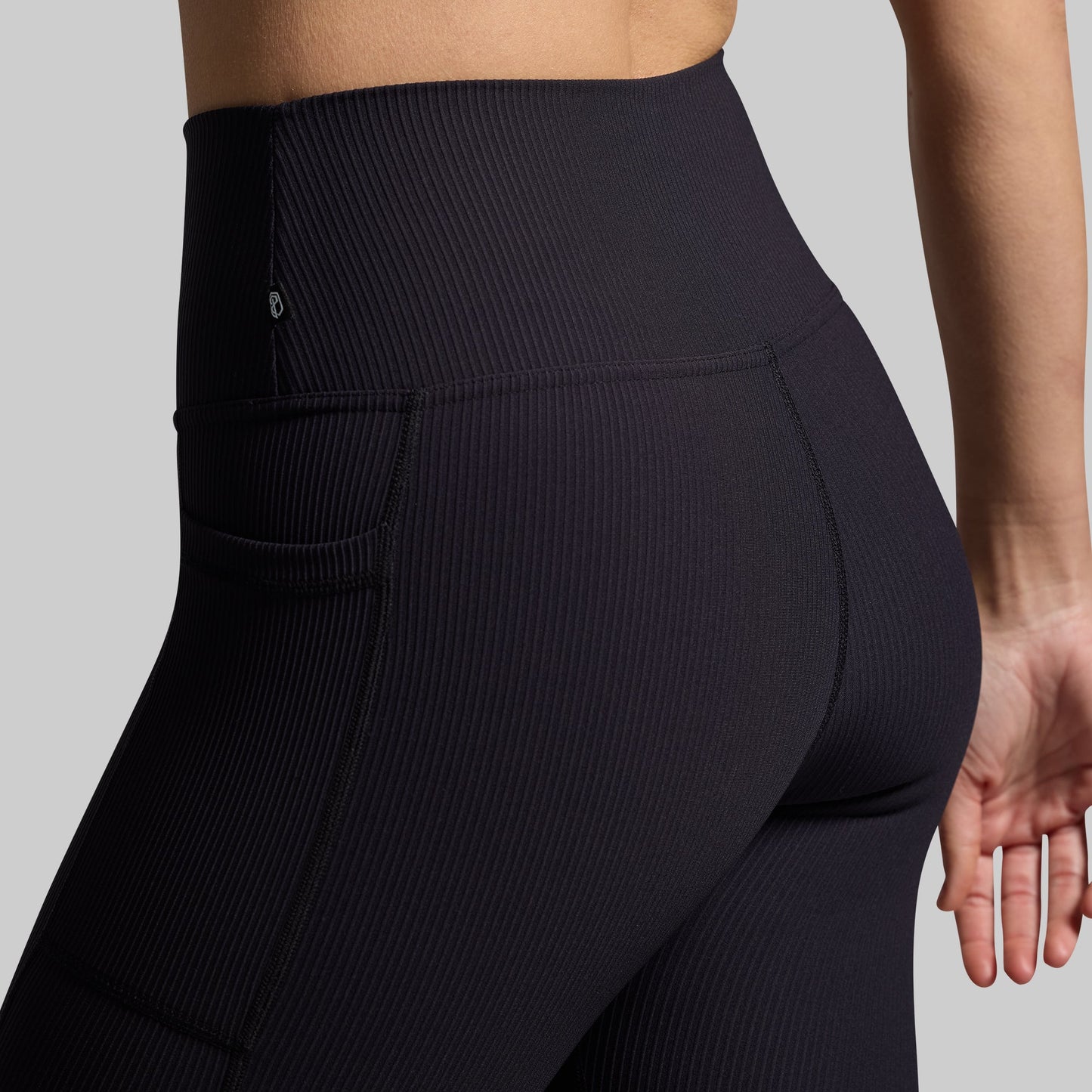 Close-up of black ribbed fabric on capris.