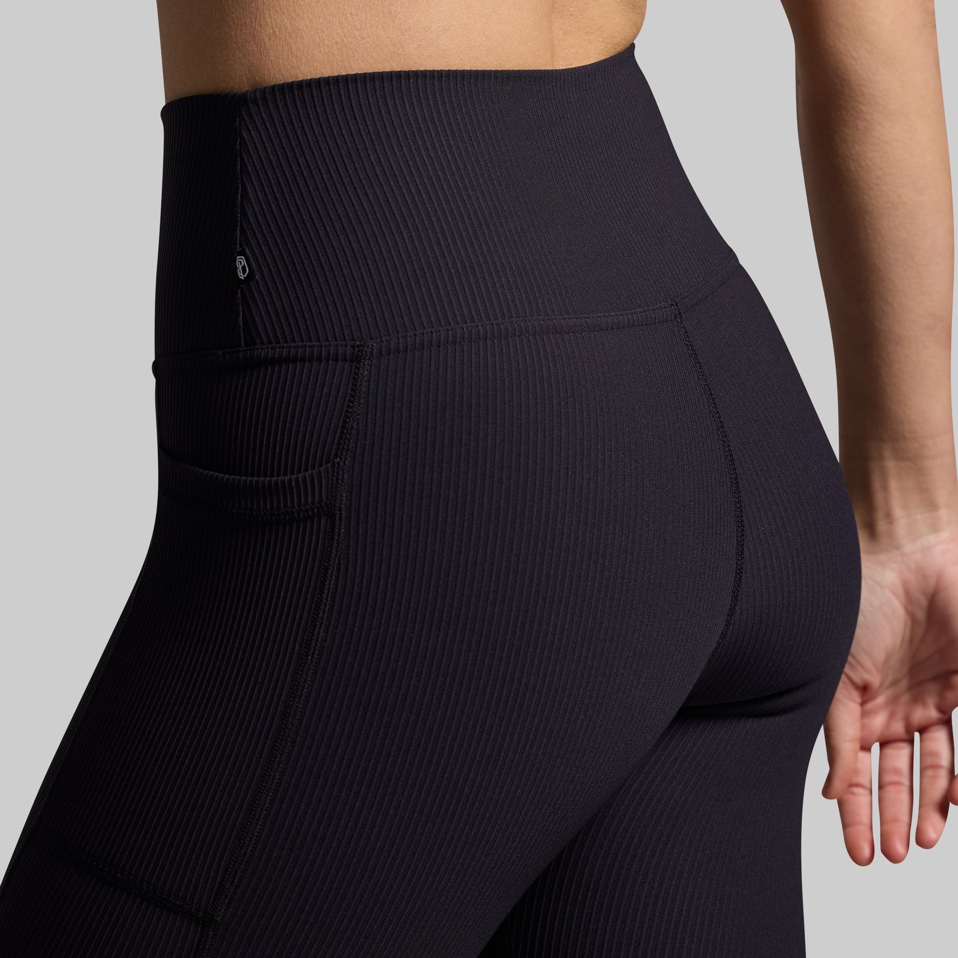 Close-up of black ribbed fabric on capris.