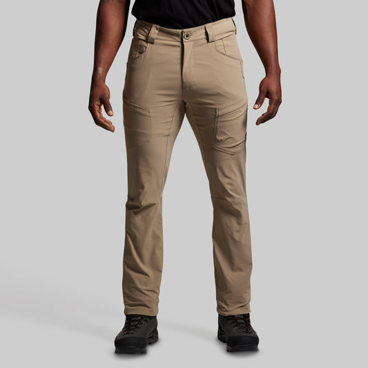 Beige pants worn by a person on a gray background